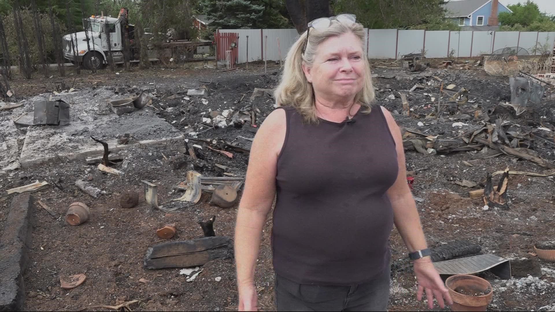 As fire crews continue to take down hazard trees and hold the fire line, a woman is picking up the pieces after her house burned to the grown last weekend.