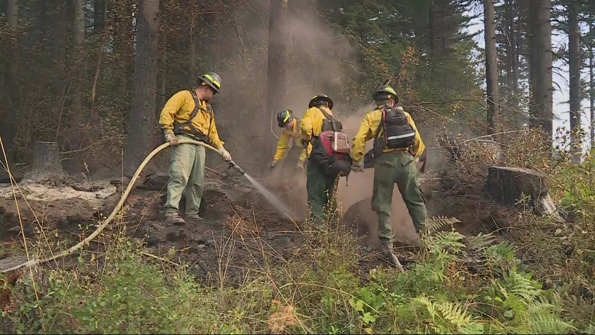 Cooler temperatures, weaker winds and less fog are helping fire crews pen in the wildfire burning north of Washougal.