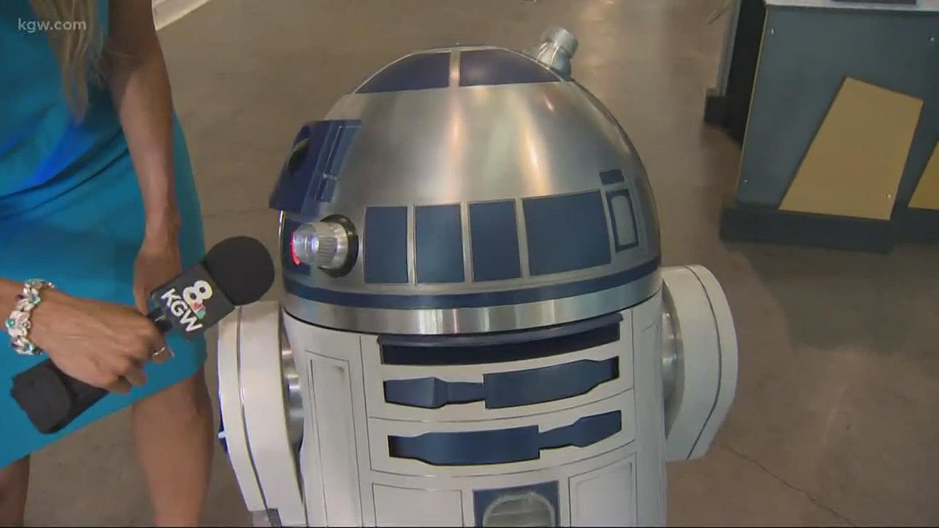 McKinzie dances with R2D2 at OMSI