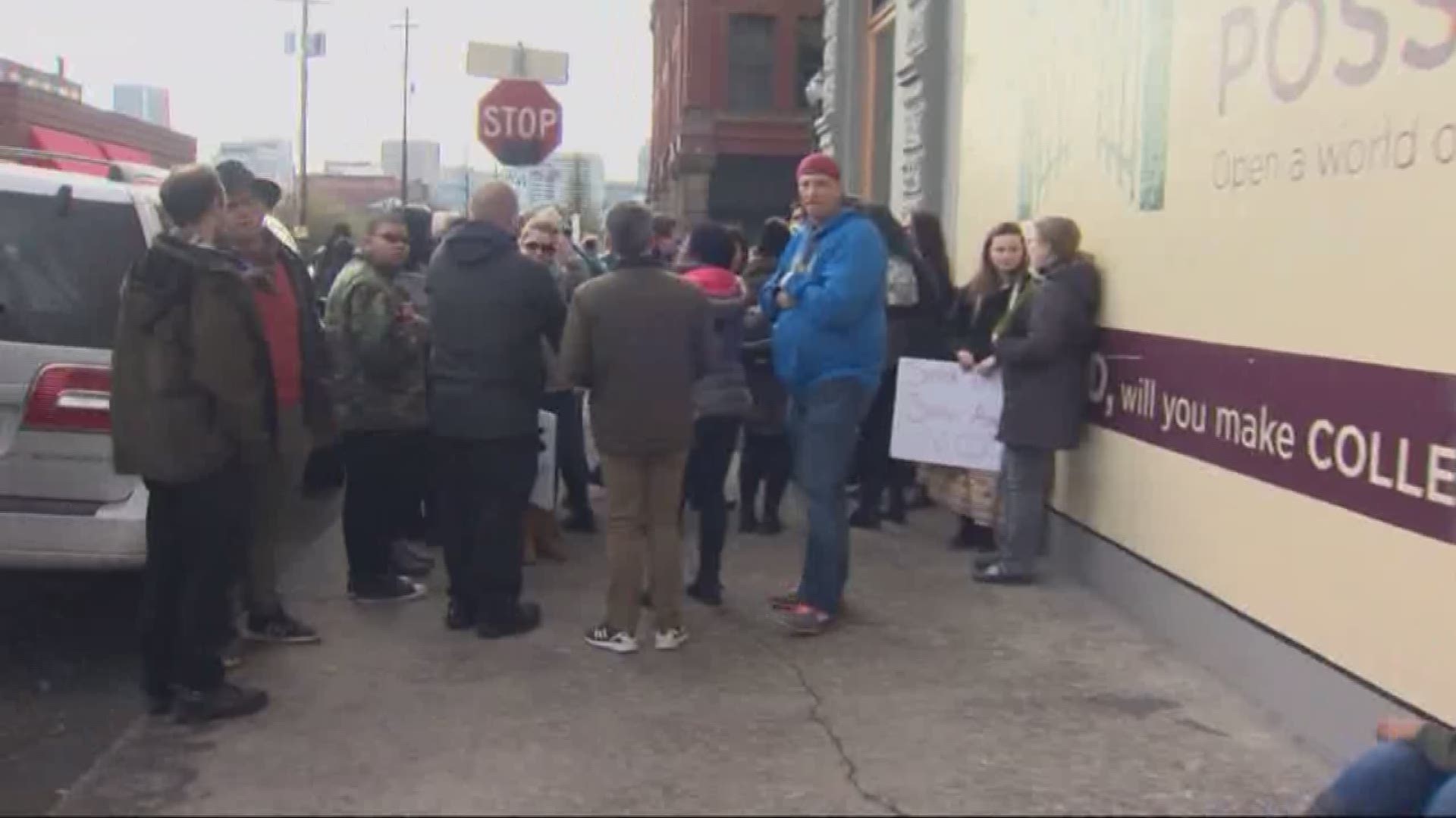 About two dozen took part in a vigil against police violence in SE Portland on Sunday after a carjacking suspect was shot and killed by Portland police officers.
