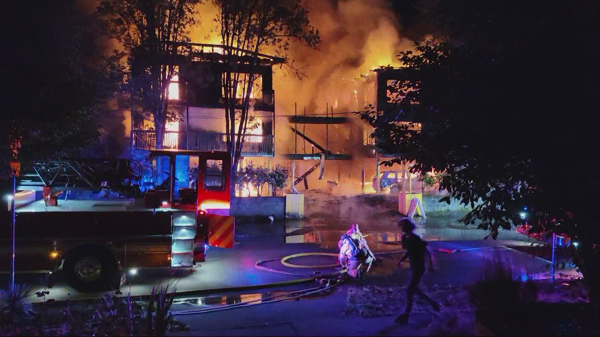 Two people have died and multiple people were injured in a four-alarm apartment building fire in NE Portland.