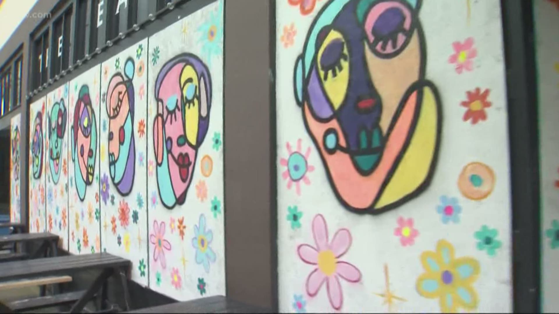 Artists are painting the plywood that covers the windows of closed businesses and spreading a message of hope.