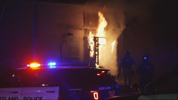 Police declare riot after person sets fire to door of Portland Police Association building