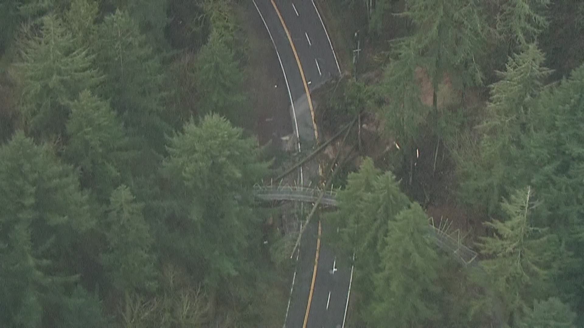 Mud, downed trees and powerlines blocked the road near the Barbara Walker Crossing.