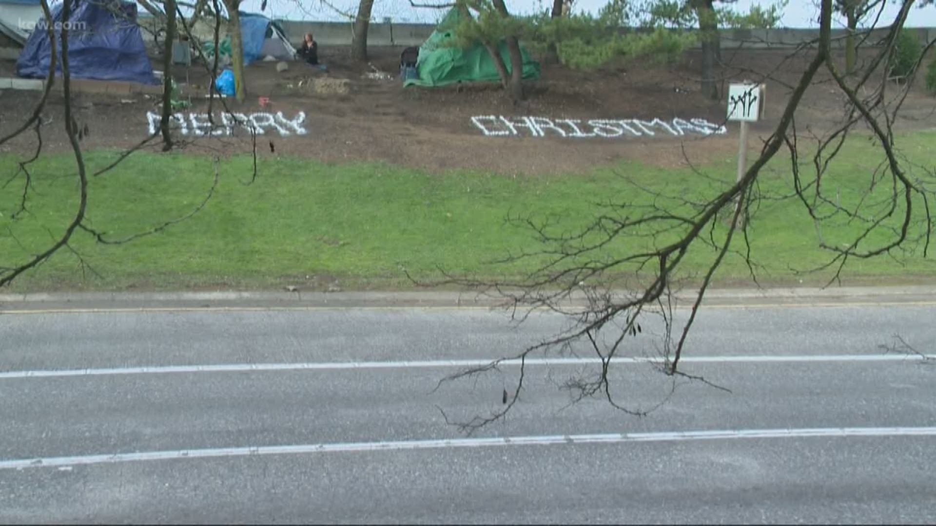 Dozens of white rocks spell the words "Merry Christmas" along the off-ramp of the Powell Boulevard exit.