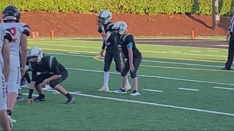 Football teams in Estacada and Camus come together for player's touchdown