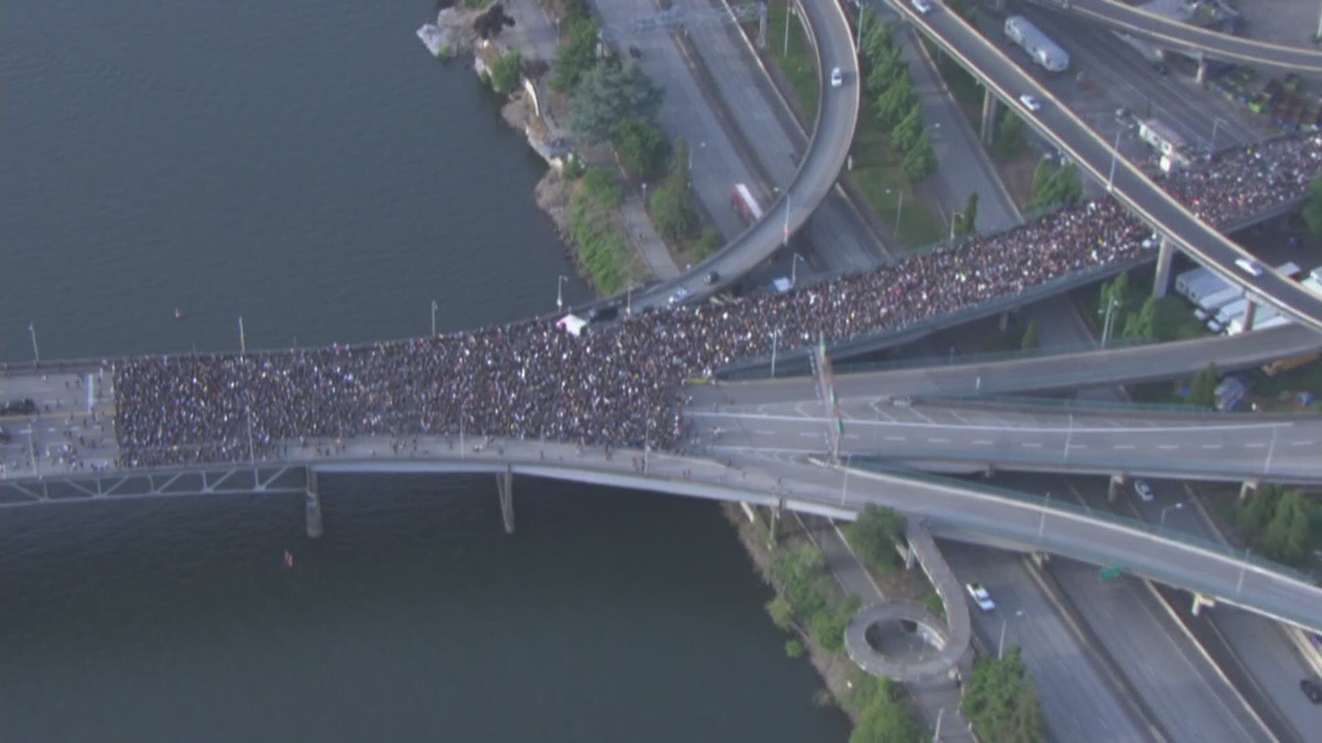 Portland Trail Blazer Damian Lillard marched at the front of a group of thousands of protesters crossing the Morrison Bridge into downtown Portland.