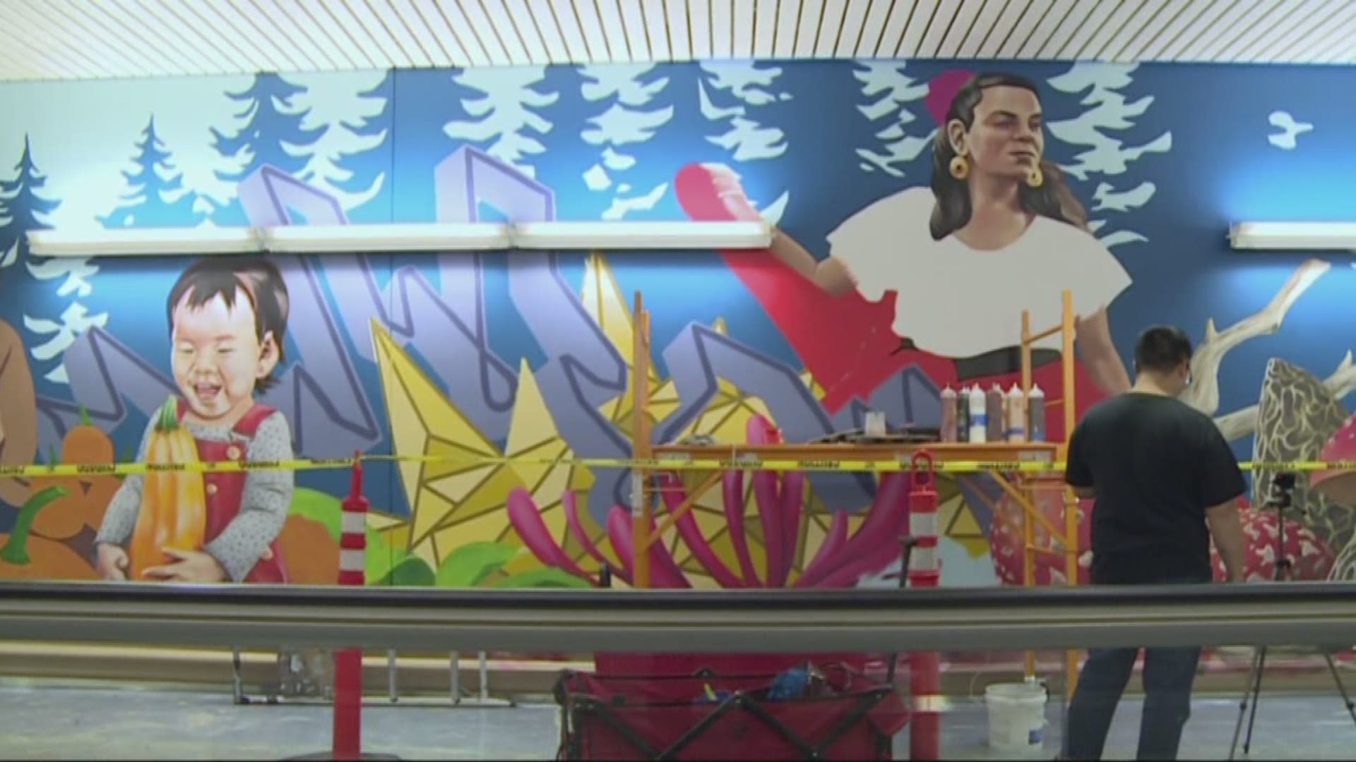 Local artists are transforming a big part of Portland International Airport. They're painting a giant mural in the north pedestrian tunnel, covering 150 feet of wall