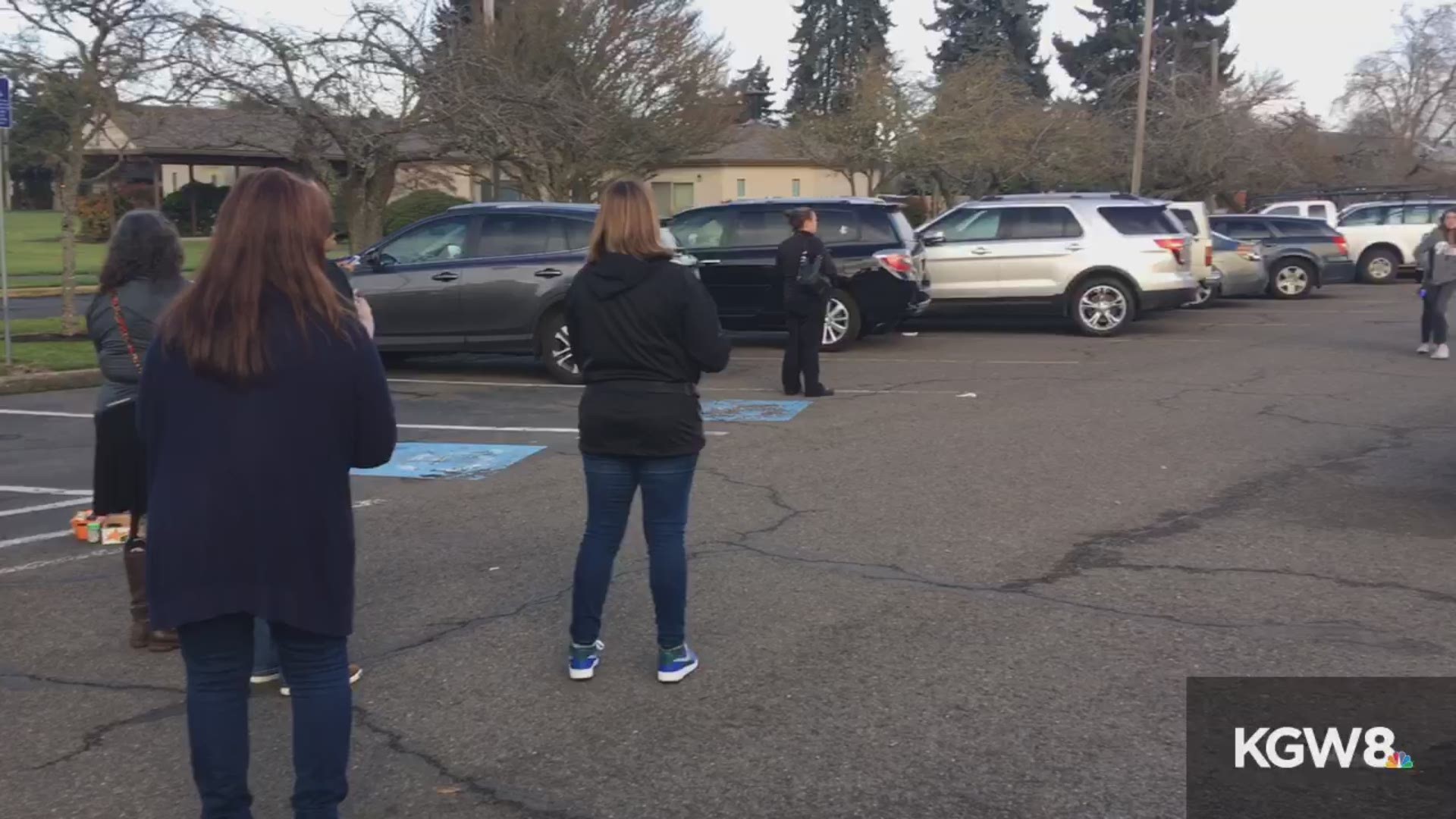 Parents hug their children when they're released from Cascade Middle School in Eugene. There was an officer-involved shooting outside the school on Jan. 11, 2018.