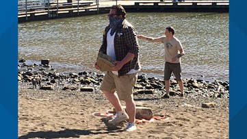 Cathedral Park beach gets a cleanup at low tide from dozens of volunteers