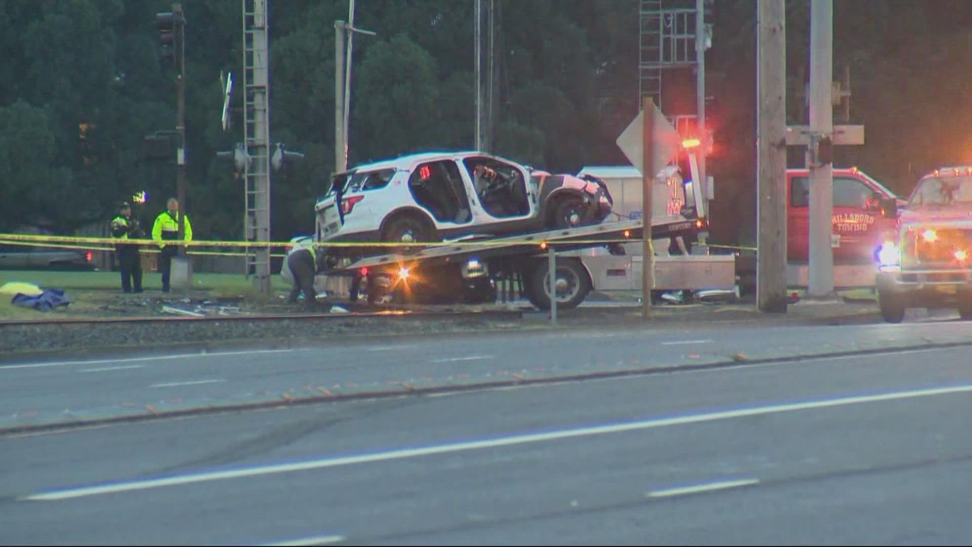 Police said a driver ran a red light at the intersection of Tualatin-Valley Highway and Murray Boulevard, hitting a sheriff's deputy patrol vehicle.