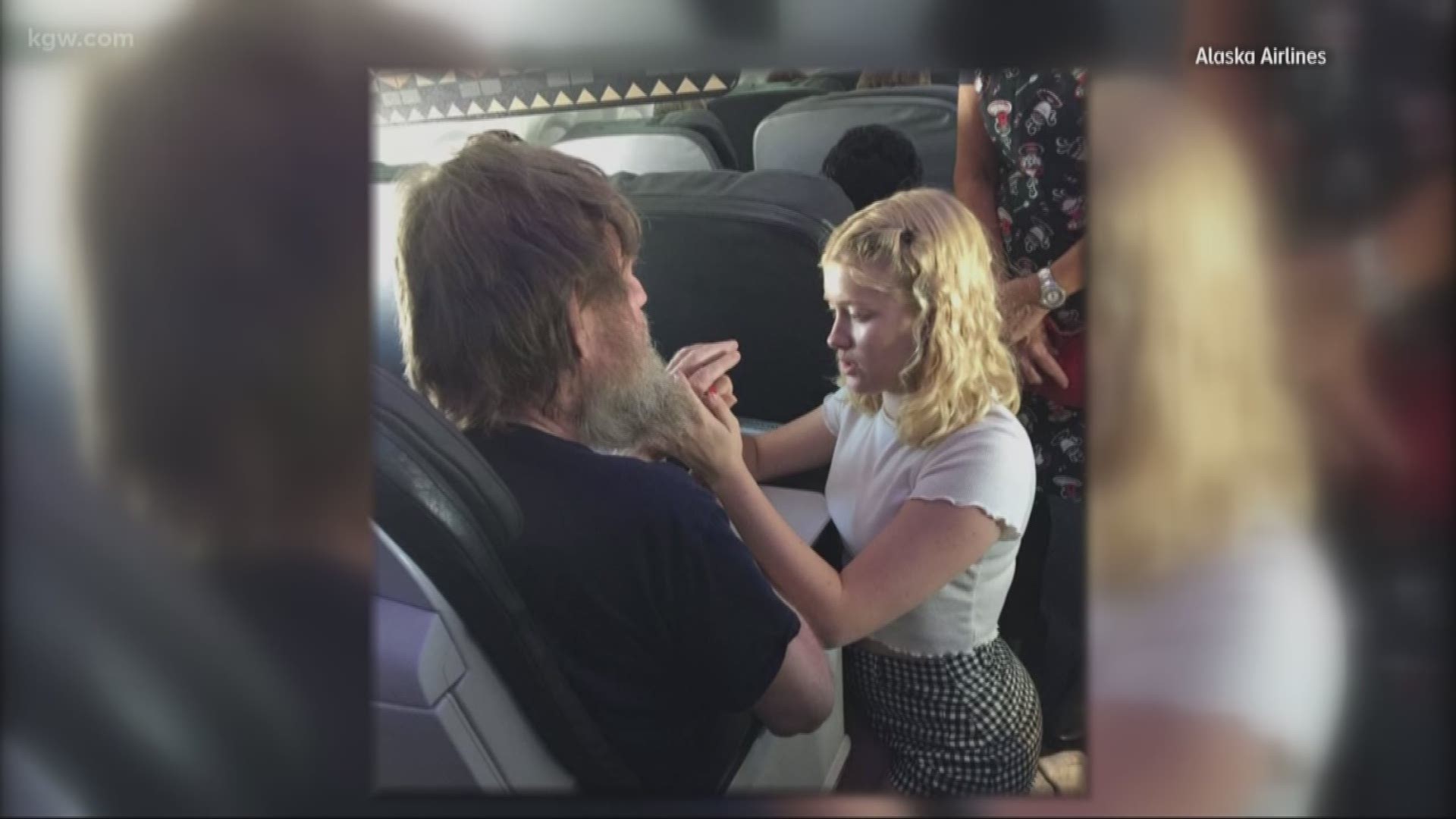 A teenager helps a blind and deaf Portland passenger aboard an Alaska Air flight.