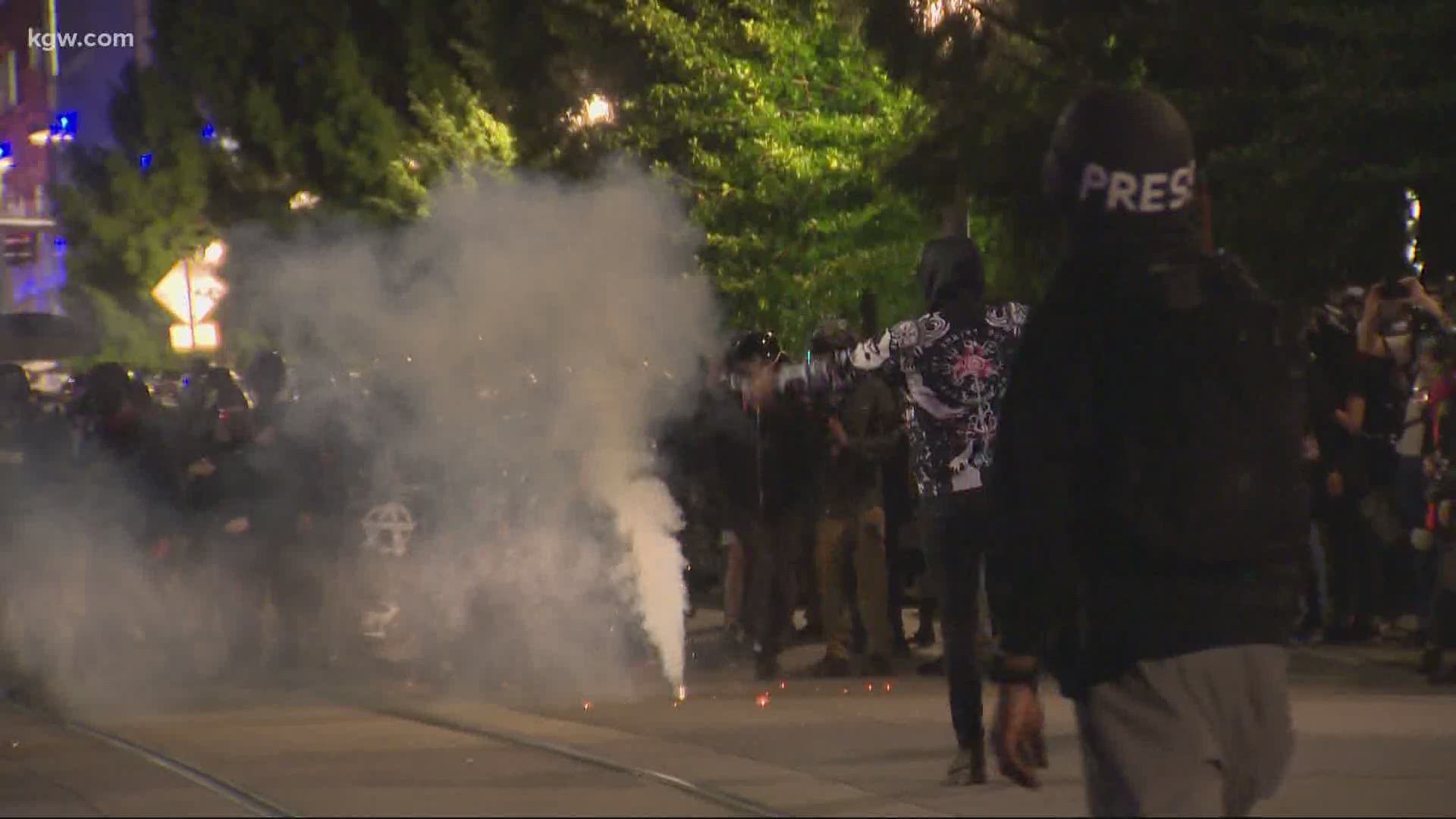 Police say demonstrators threw rocks and glass bottles at officers. Officers fired tear gas and other munitions at the crowd, according to police.