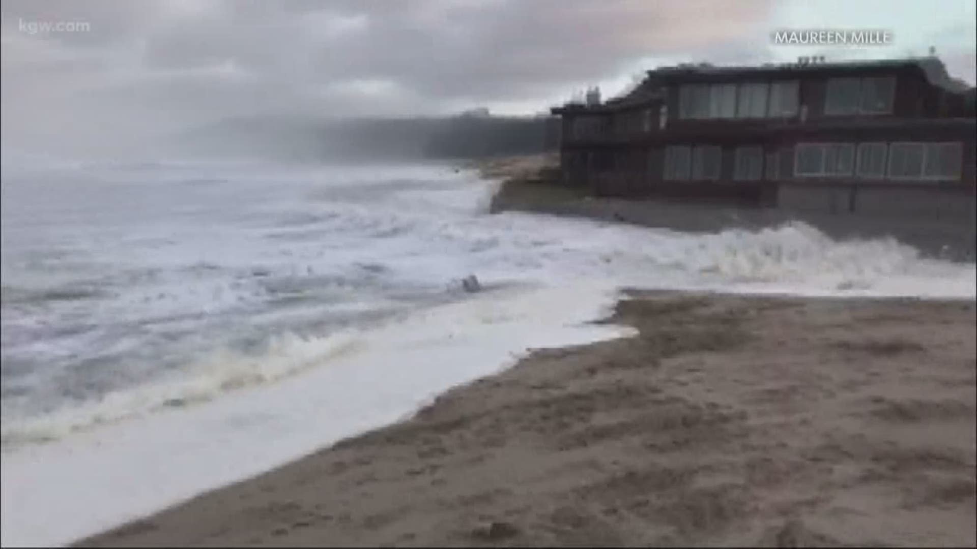 A massive sneaker wave slams into the seawall at Cannon Beach in December 2018. The wave sets logs loose and surges up a paved beach