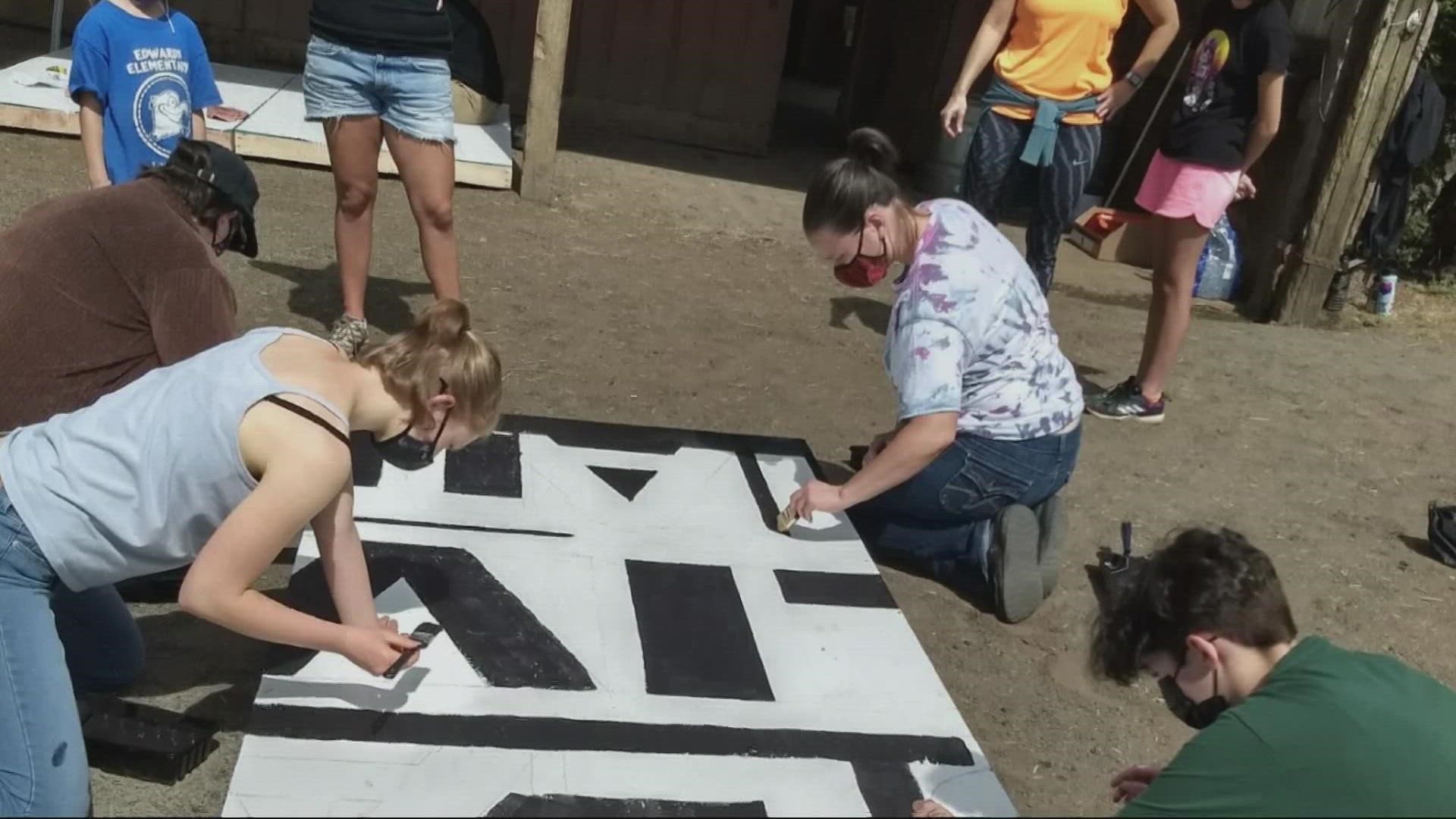 A large, plywood Black Lives Matter flag was built next to a Pride display in Newberg following the school board's vote to ban both symbols from its schools.