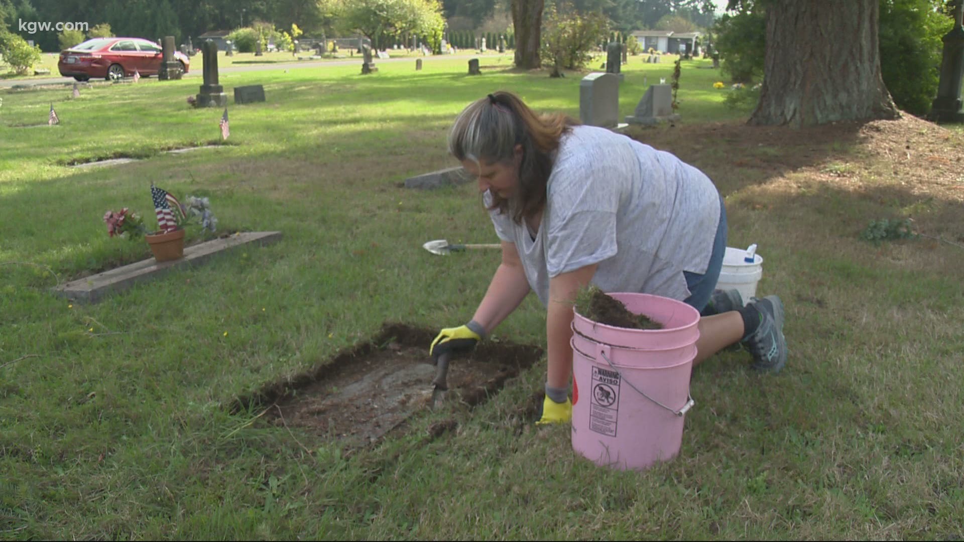 A woman washes away years of dirt and grass from headstone in a small cemetery south of Olympia. Devon Haskins has her story.