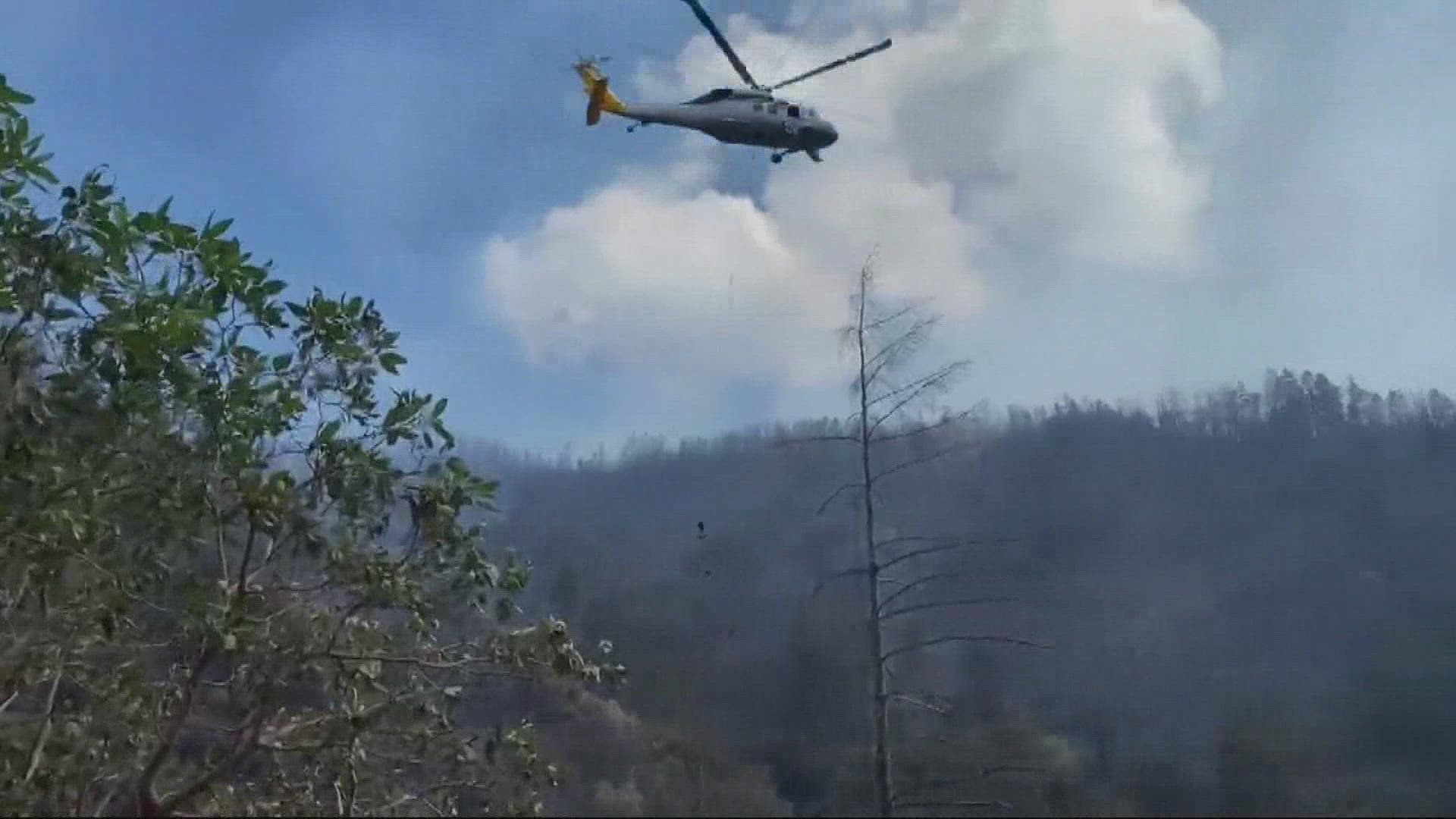 A wildfire in remote southwest Oregon continued its rapid spread through a rural area and destroyed several structures, authorities said Sunday.