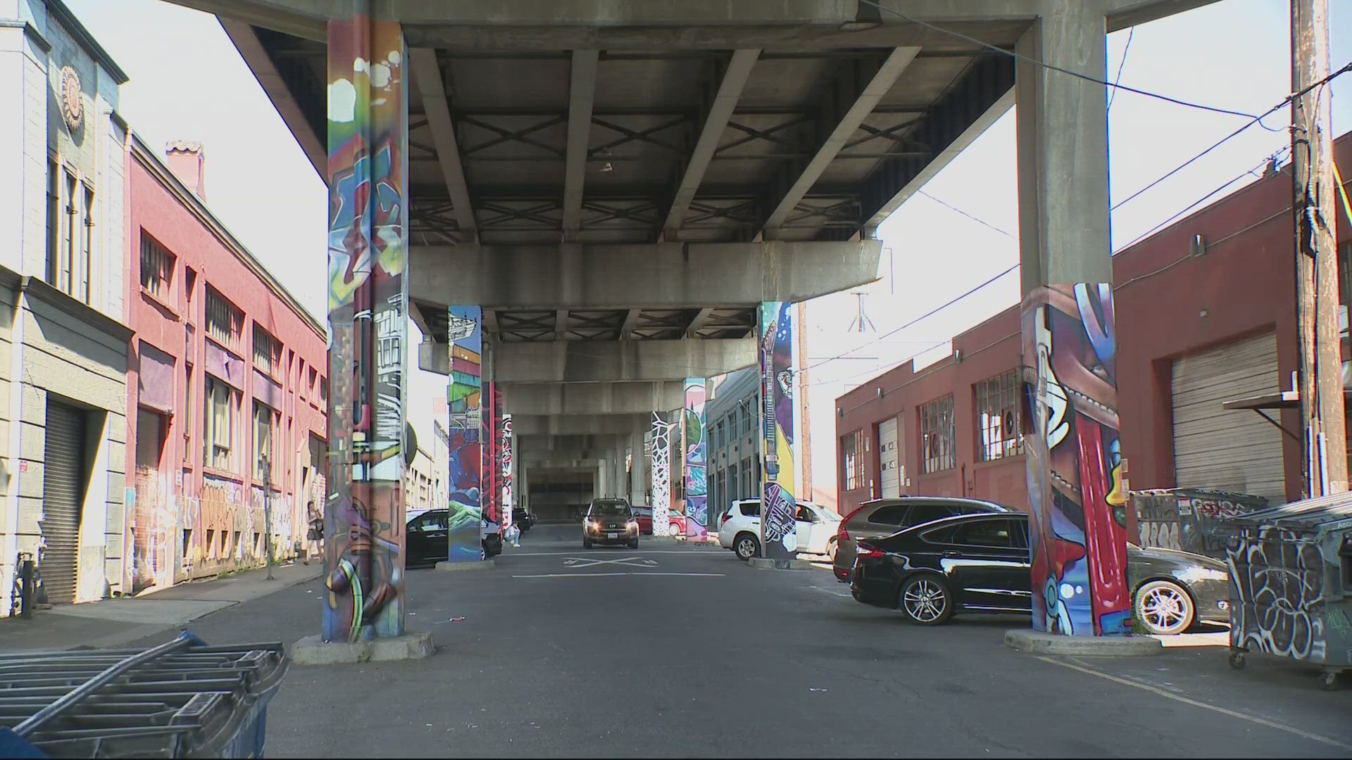 Cyclists gathered Friday evening to enjoy the new murals that cover pillars in an area of the city on Southeast Madison that's seen hard times.