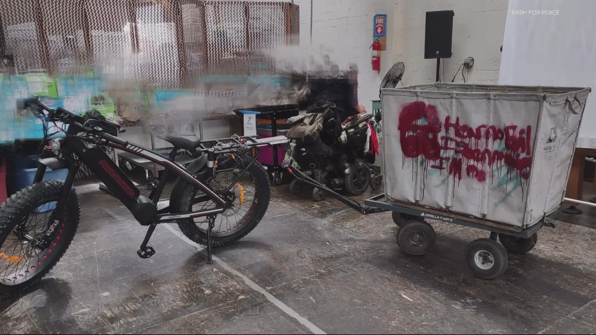 ‘Trash for Peace’ picks up trash around the city using an e-bike and trailer. But they’ve had to pause operations after someone stole the bike last week.