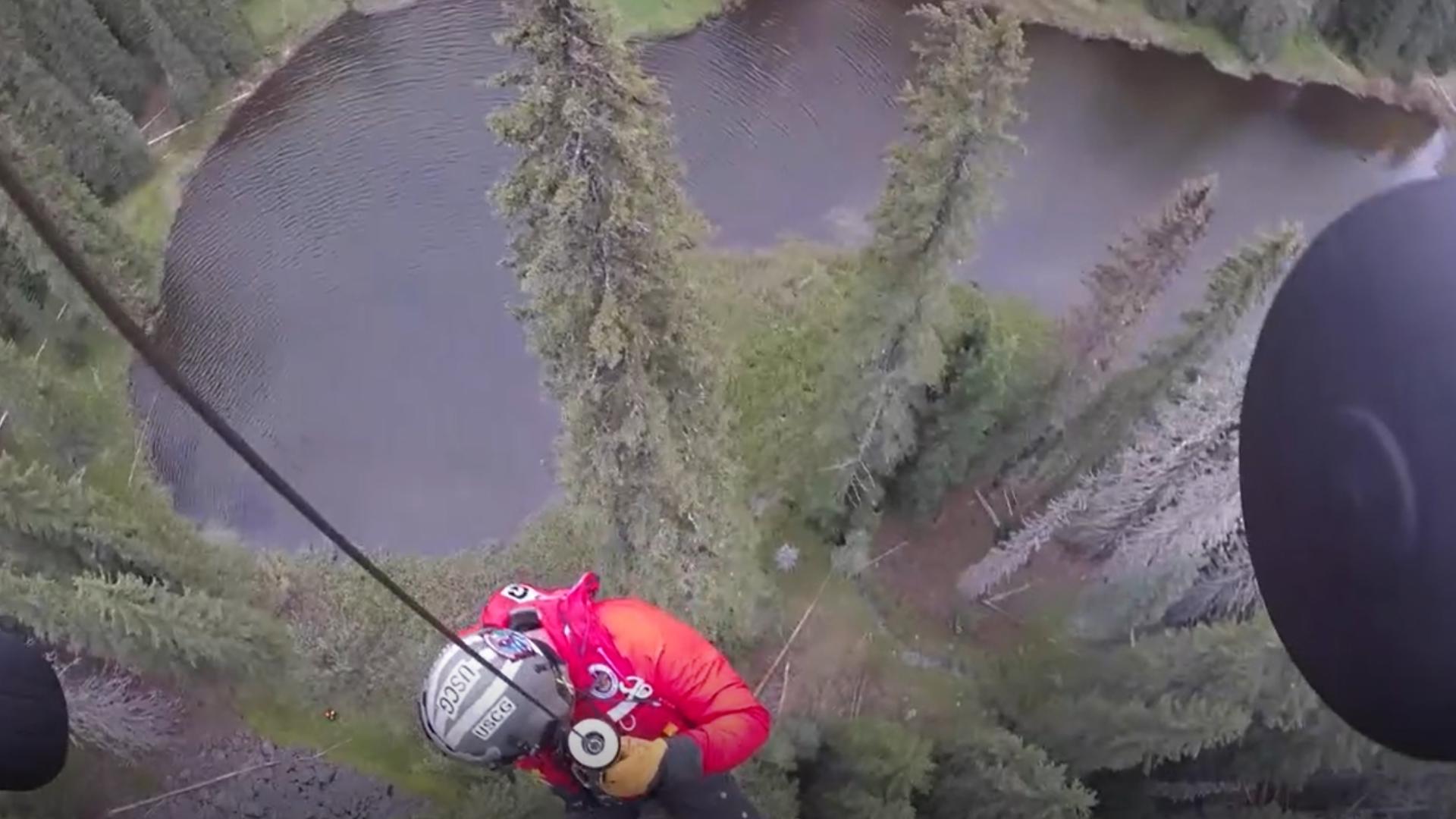 The Oregon Coast Guard drops rescue swimmers in to rescue two stranded hikers and a dog