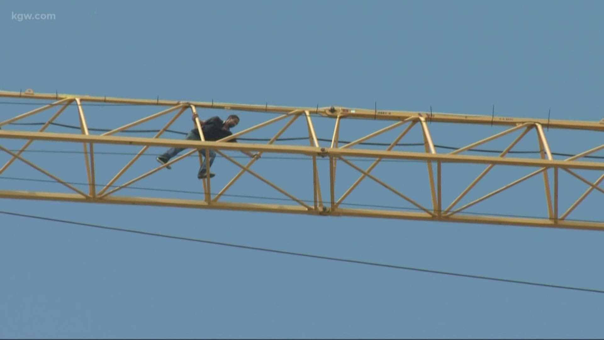 Man who climbed crane is safe