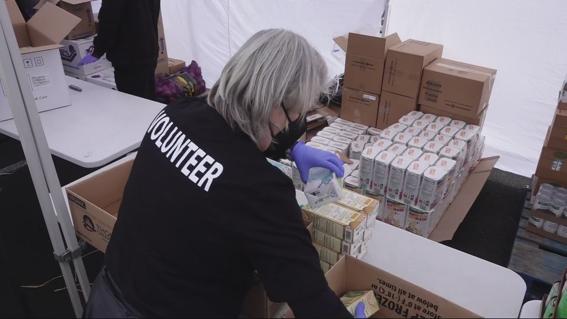 Virginia Garcia Memorial Health Center has collaborated with the Oregon Food Bank to feed families. Volunteers hand out food at a drive-thru food pantry in Beaverton
