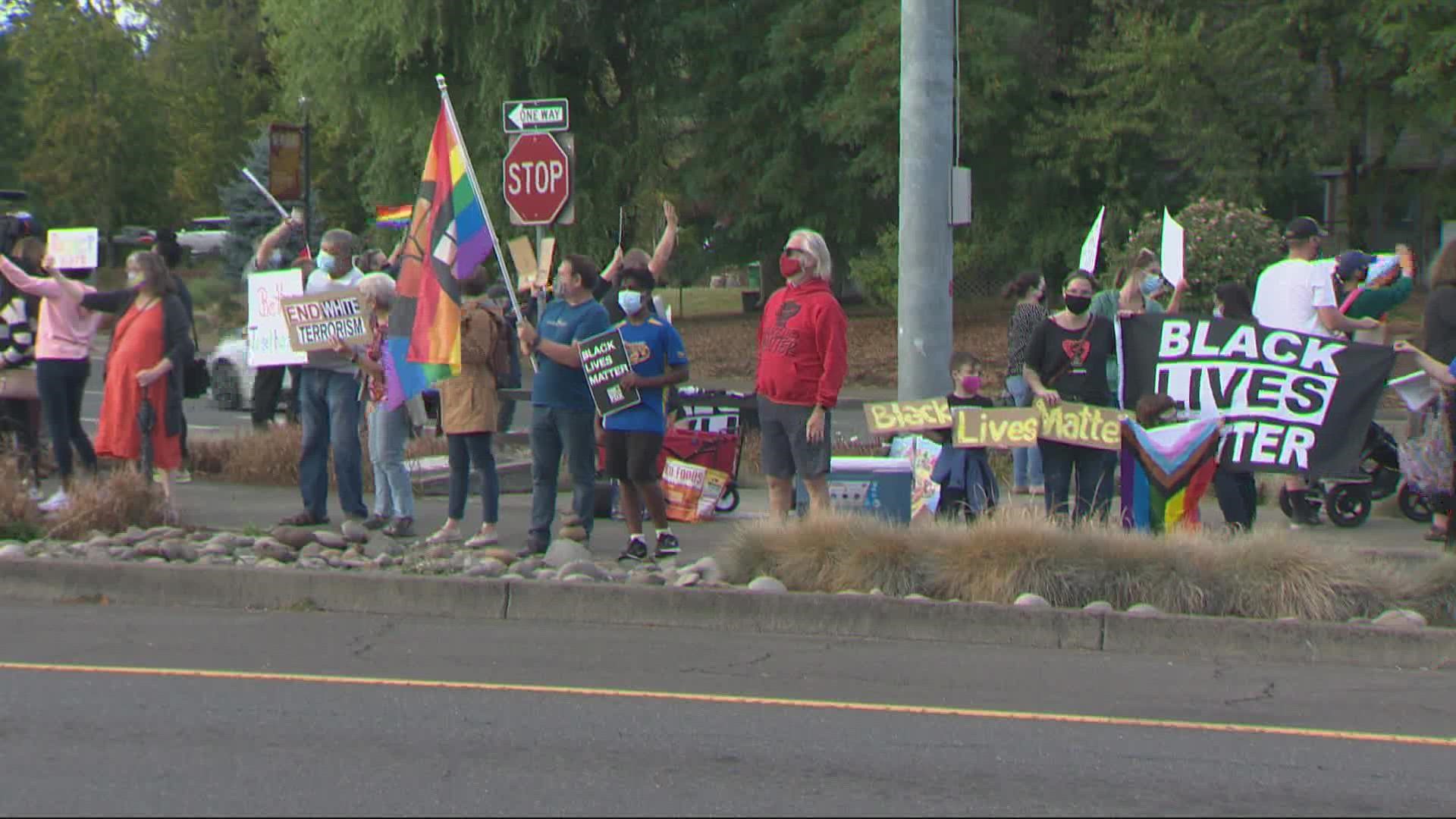 Dozens descended on the intersection of Highway 99 and South River Street in Newberg on Sept. 22 to rally against hate.