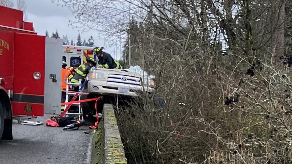 Vancouver firefighters cut roof off truck perched above Salmon Creek to rescue suspected DUI driver