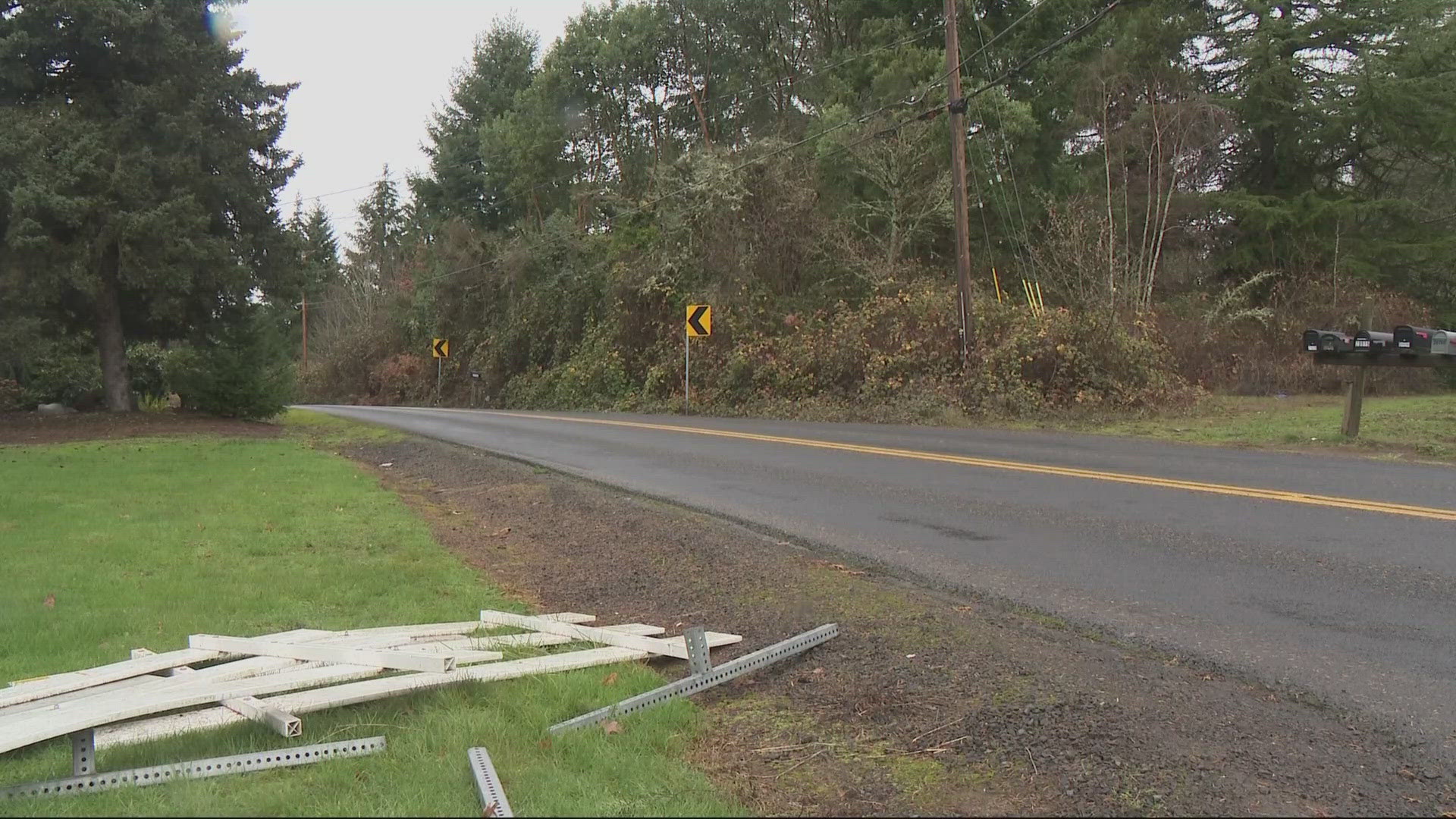 A man has been arrested after the death of his partner, found lying in the road near her home.