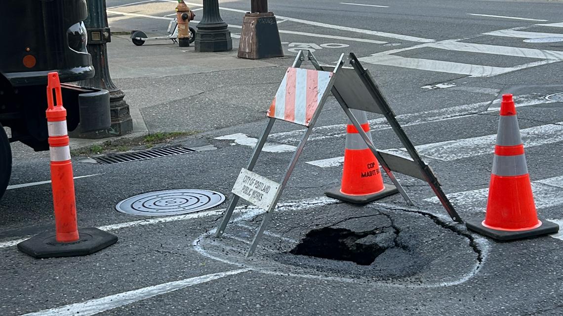 The sinkhole is located at Southwest Alder Street and Southwest 2nd Avenue just before the Morrison Bridge; one lane...