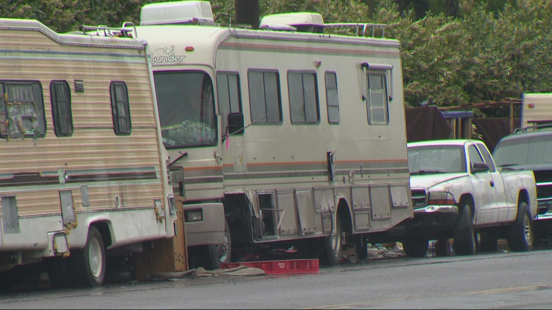 Police said someone in a moving truck tossed an explosive under an occupied RV in Northeast Portland. The woman inside was not injured.