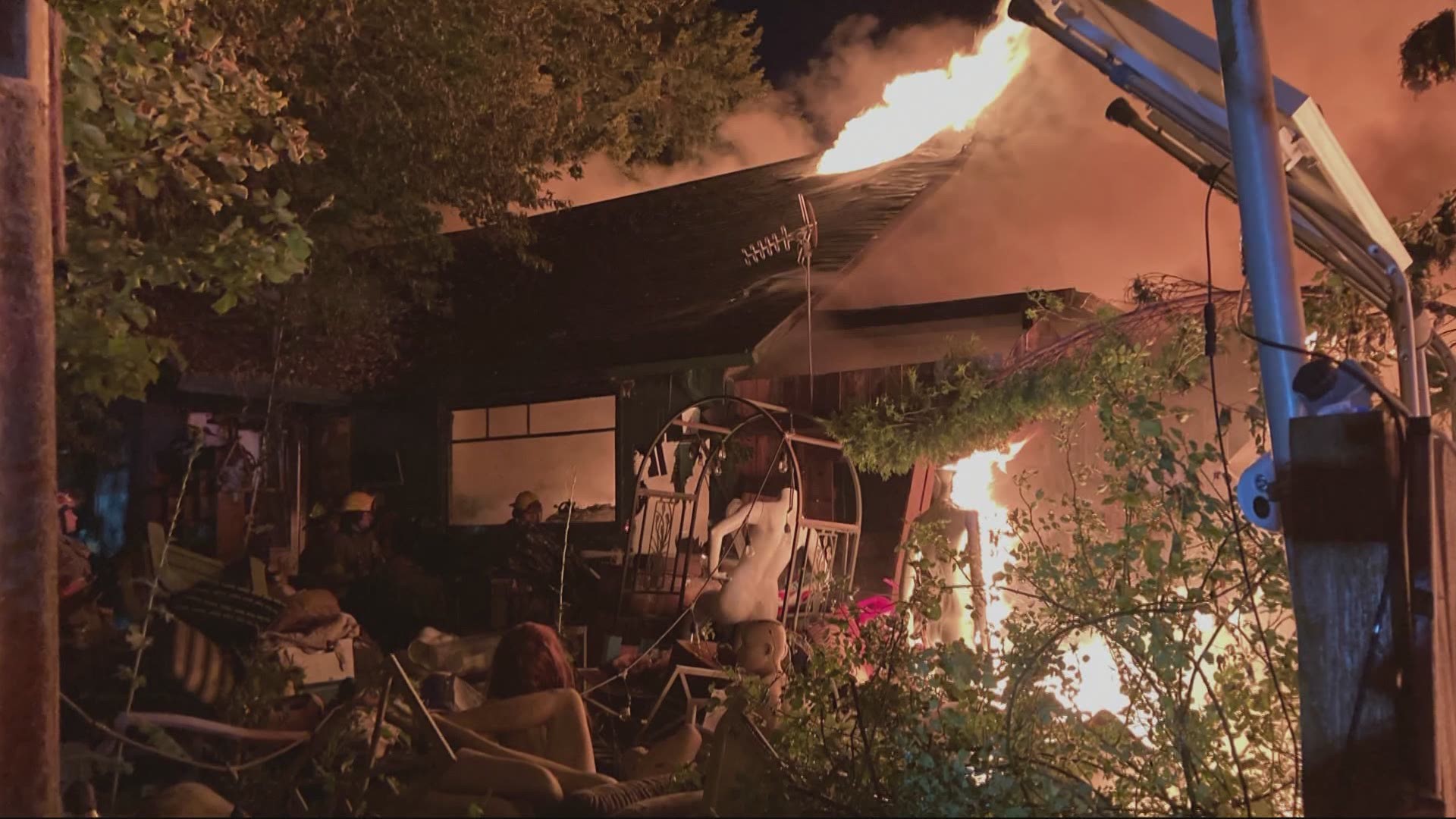 Fireworks may be to blame for a fire that burned a home and church building in Battle Ground, filled with a man’s lifelong collection of mannequins and dolls.