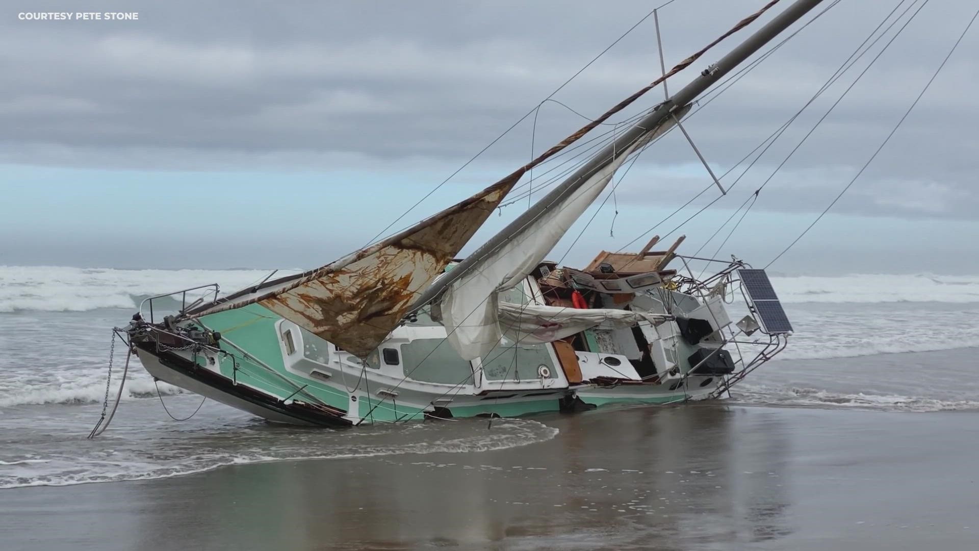 A sailboat washed up at Nedonna Beach, Ore., just north of Rockaway Beach, on Sunday, Oct. 3, 2021. Two bodies were found in the water near the boat, the USGS said.