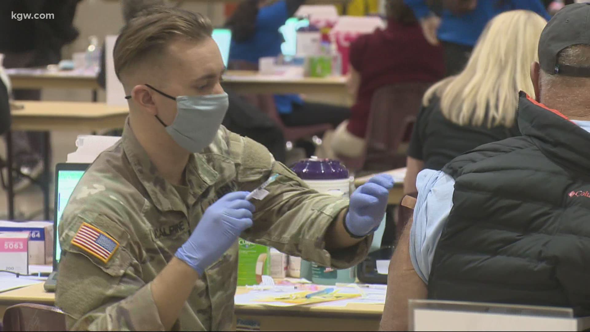 Oregon National Guard members are helping vaccinate people in Phase 1a, as Gov. Kate Brown is expanding the list of people who can get vaccinated.