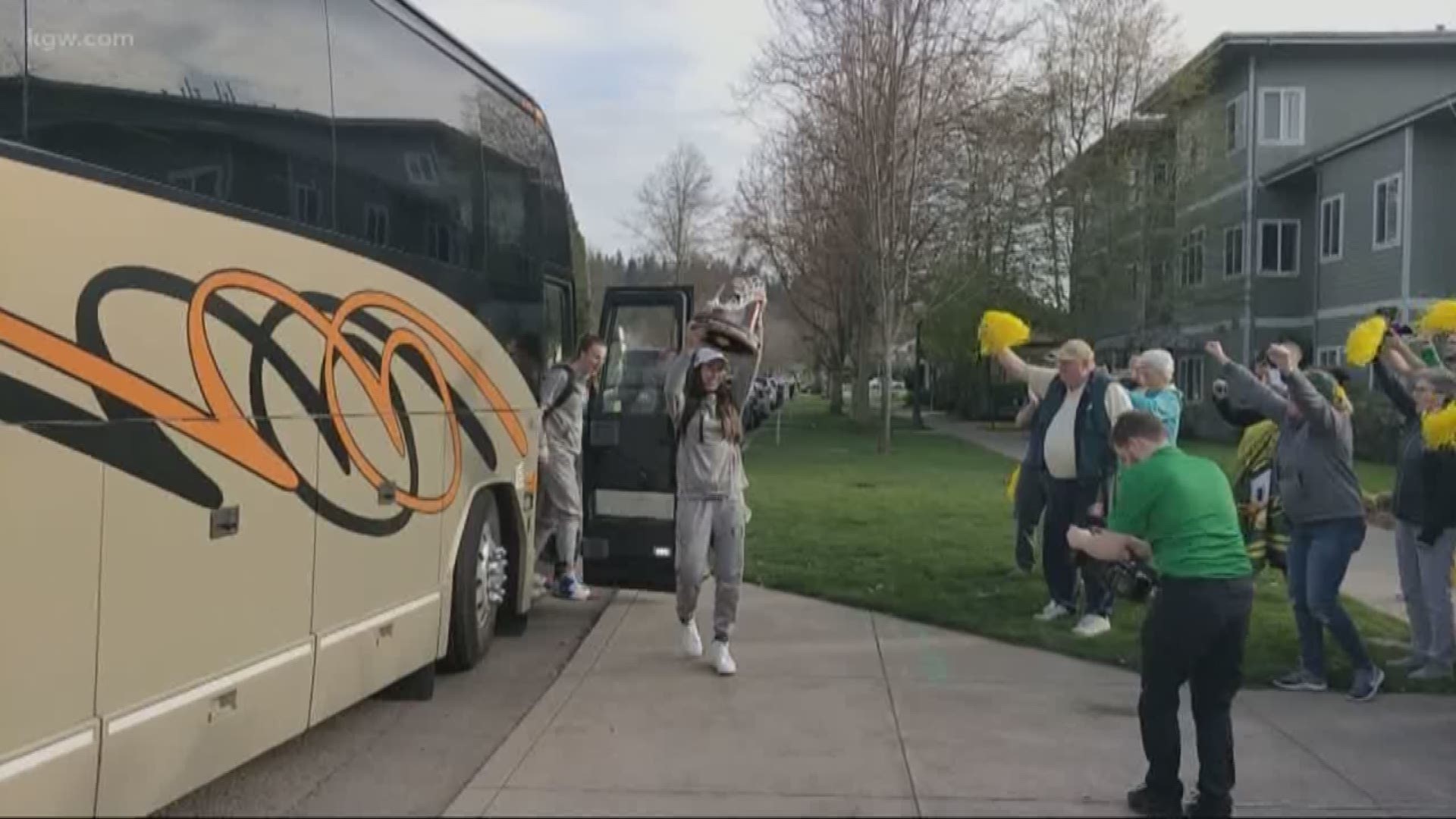 Fans cheer the Final Four Ducks as they arrive back in Eugene