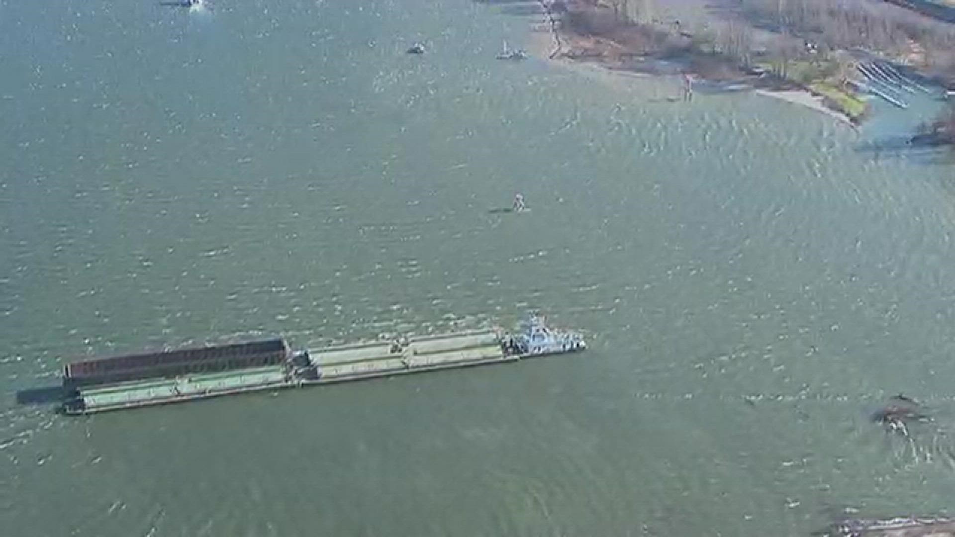 A Tidewater tug hauling three grain barges and one empty bin barge ran aground after being pushed by heavy winds.