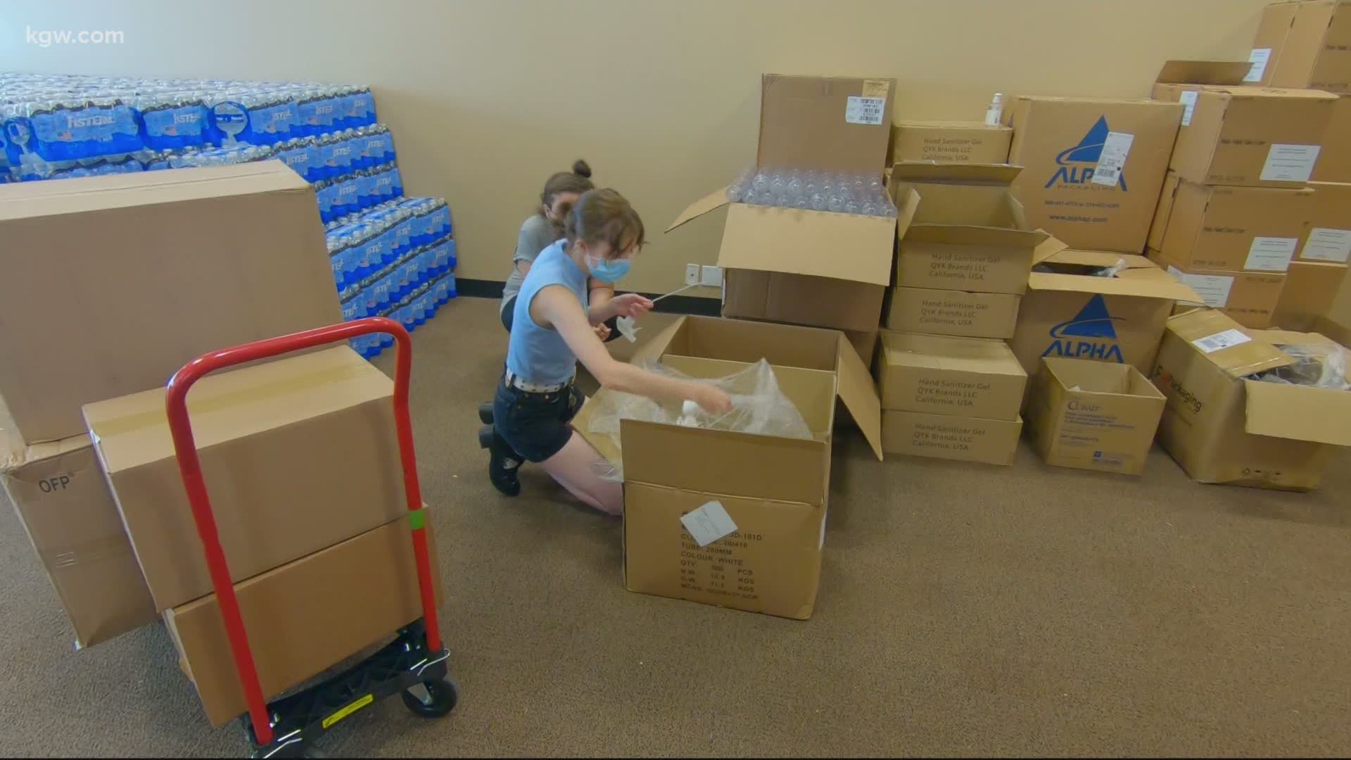 Volunteers spent the day distributing supplies to help Portland's houseless community cope with the heat.