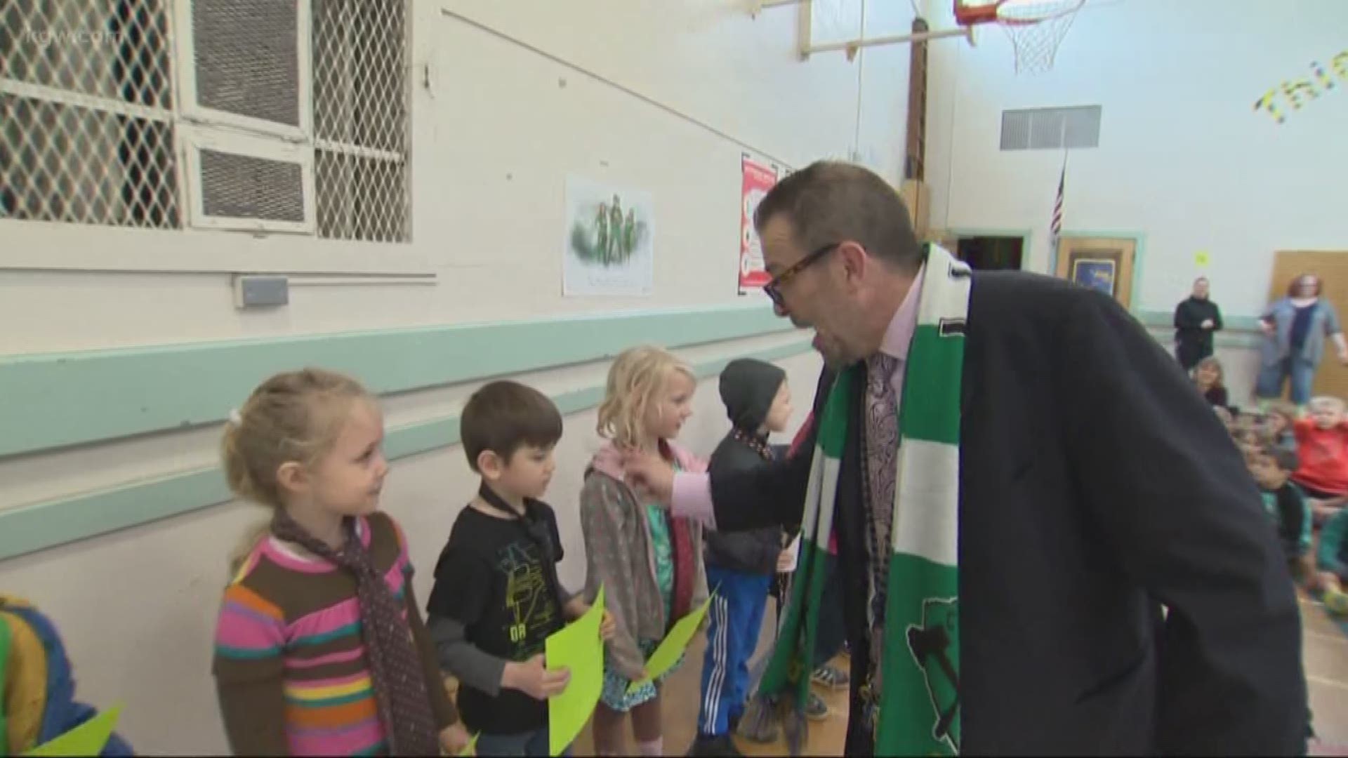 The principal of Llewelyn Elementary School is rewarding students with neckties.