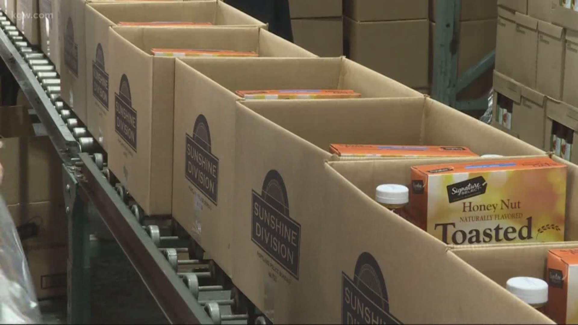 The Portland Police Bureau Sunshine Division, Advantis Credit Union and Safeway volunteers prepared food boxes as part of program to feed hungry students through the summer.