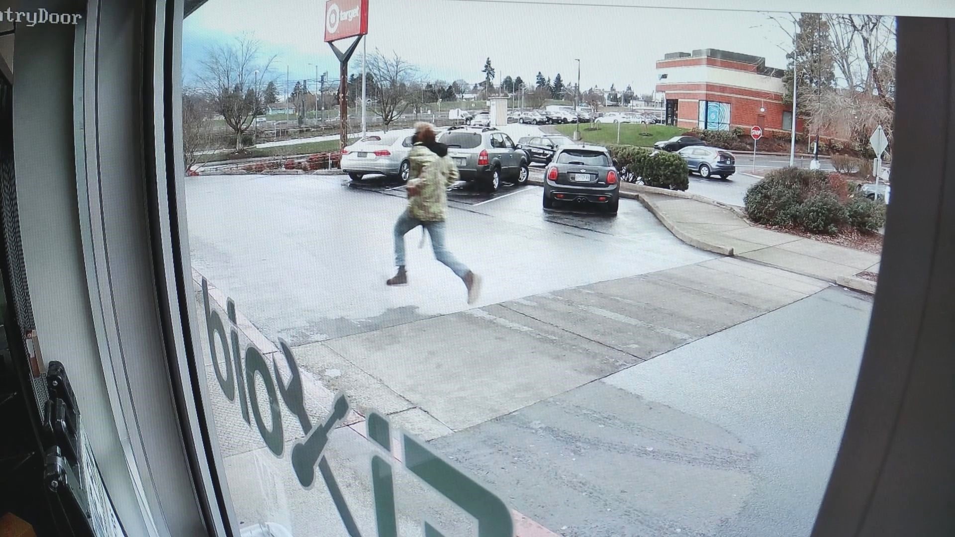 Surveillance video from a nearby storefront shows a robbery suspect running across the Mall 205 parking lot moments before he was shot by police.
