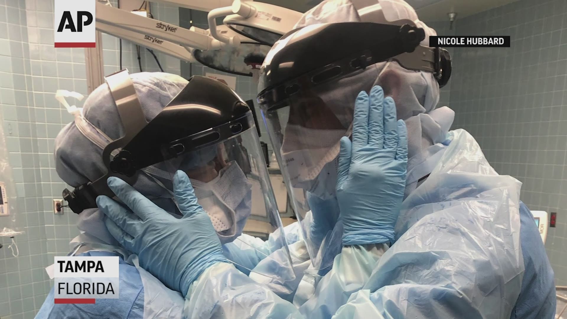 Mindy Brock, husband Ben Cayer work as nurse anesthetists at Tampa General taking on the high-risk duty of placing breathing tubes in surgery patients with COVID-19.